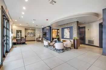 A spacious living room with a curved wall and a fireplace.